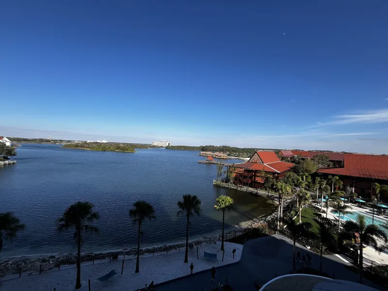 View from Island Tower's terrace over the Polynesian's beach, palm trees, pool and red-roofed longhouses to Seven Seas Lagoon